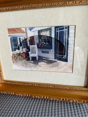 Framed Coastal Porch Print with White Rocking Chair and Flowers